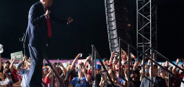 US President Donald Trump dances as he leaves a Make America Great Again rally as he campaigns at Orlando Sanford International Airport in Sanford, Florida, October 12, 2020.