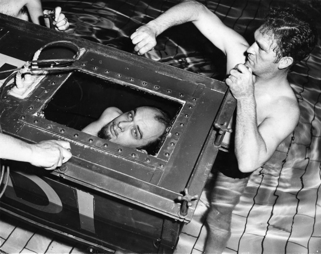 The Amazing Randi peers out from the sealed coffin in which he will attempt to break his own endurance record of staying two hours under water. (Ron Burton/Getty Images)