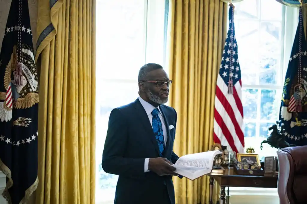 Bishop Harry Jackson, senior pastor at Hope Christian Church in Beltsville, Maryland, offers a blessing to President Donald Trump in the Oval Office of the White House on April 10, 2020