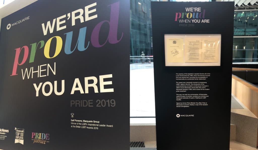 A lobby window (L) and a display detailing how Section 28 was repealed at Pride at Macquarie 2019. (Supplied)