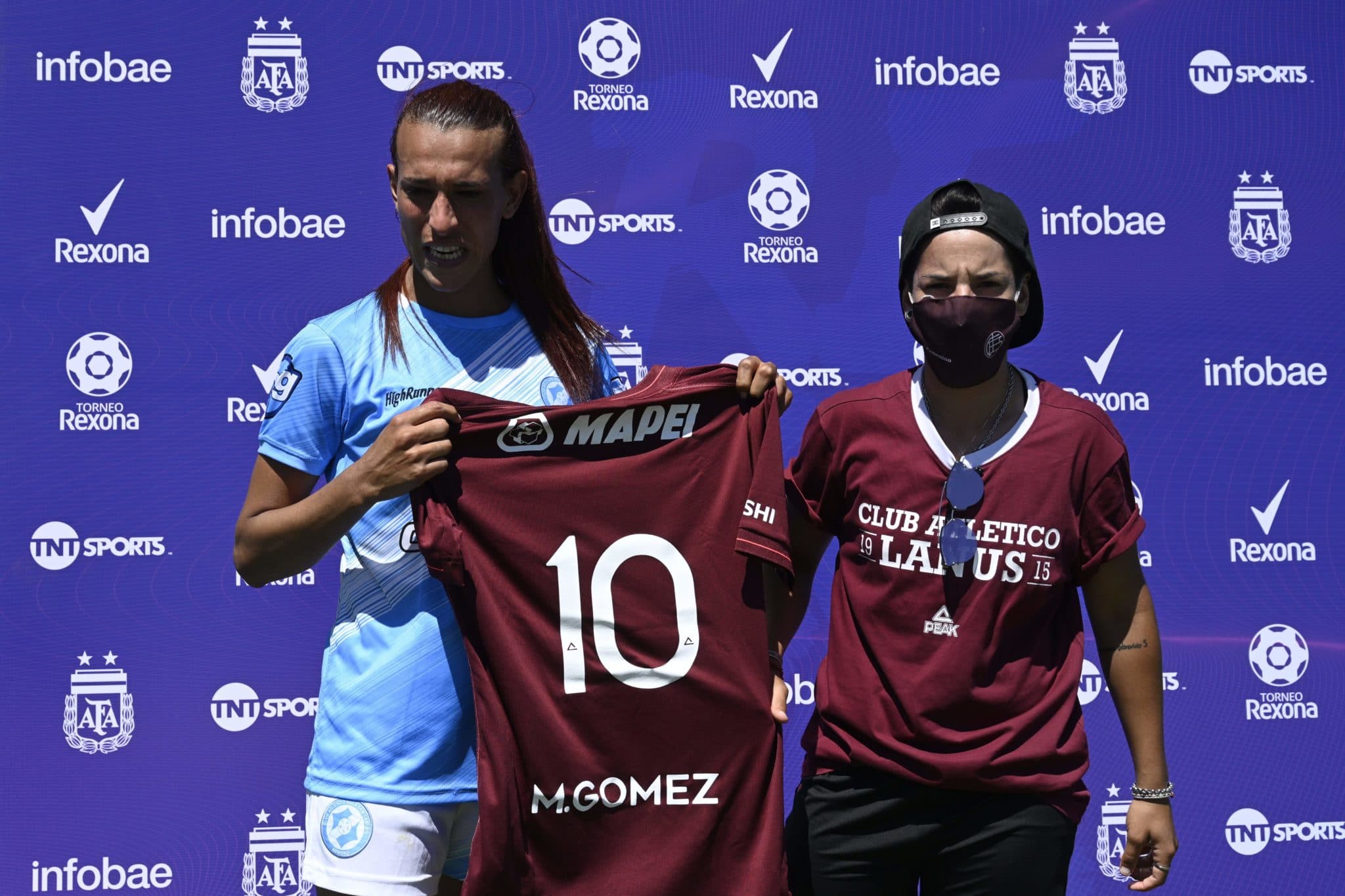 Mara Gómez poses with a jersey of Lanus with her name on it given as present after an Argentina first division female football match