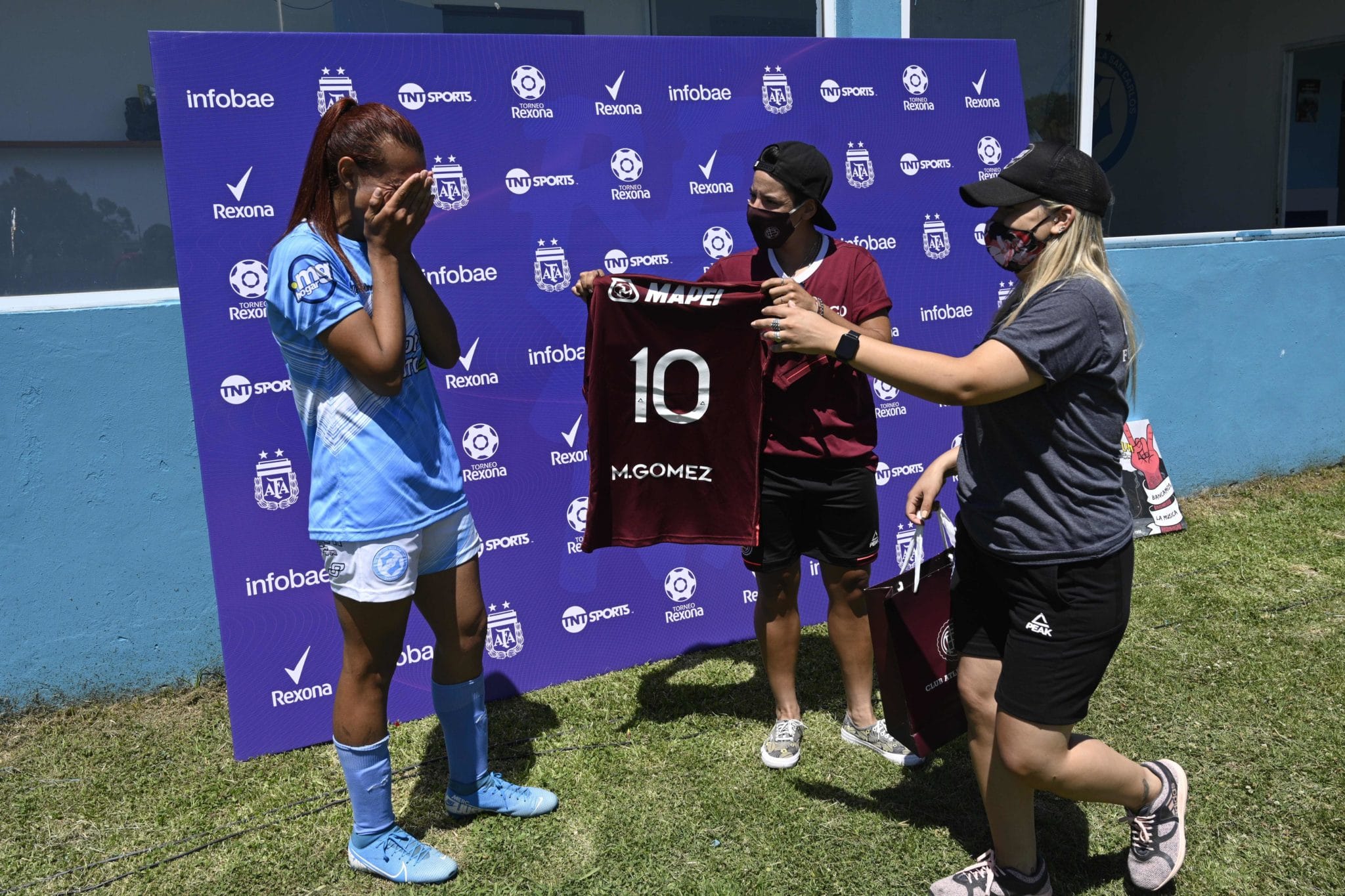Mara Gomez of Villa San Carlos reacts emotionally as she is given a jersey of Lanus with her name on it 