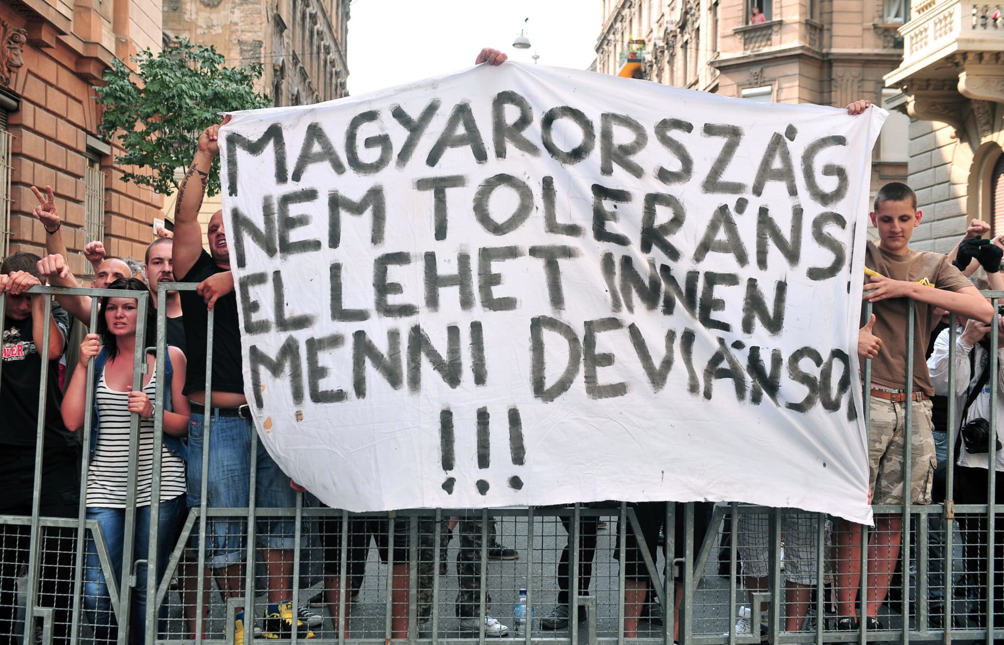 Nationalists hold a banner reading 'Hungary is not a tolerant country, go way deviants' during a Hungarian gay pride parade