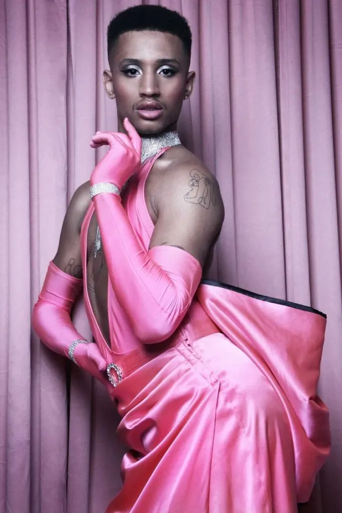 Tyreece in a pink satin gown with a big bow on the back