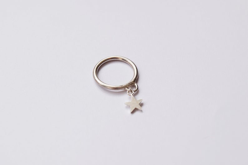 An anxiety ring with a star charm. (3crownsShop)