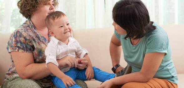 lesbian mothers playing with child