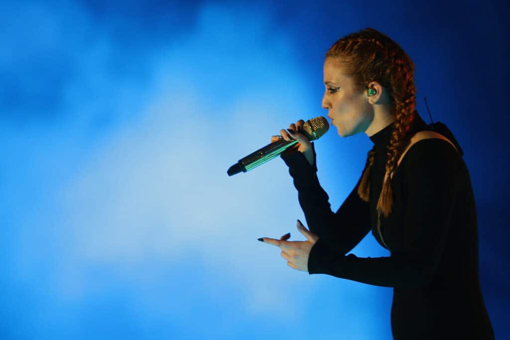 Jess Glynne sings into the microphone