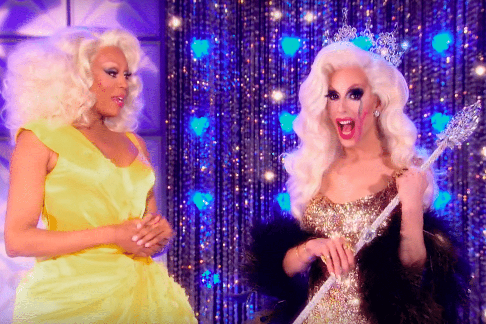 RuPaul standing next to Alaska, who is wearing a crown and holding a sceptre