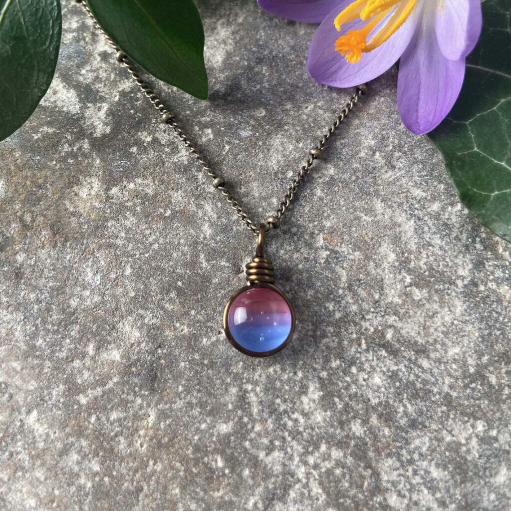 A bisexual necklace. (Etsy/WeatheredHeather)