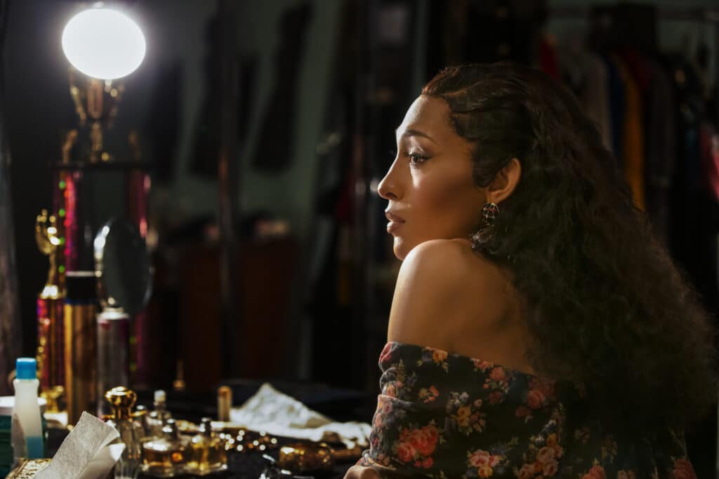 Mj Rodriguez as Blanca, staring into a vanity mirror