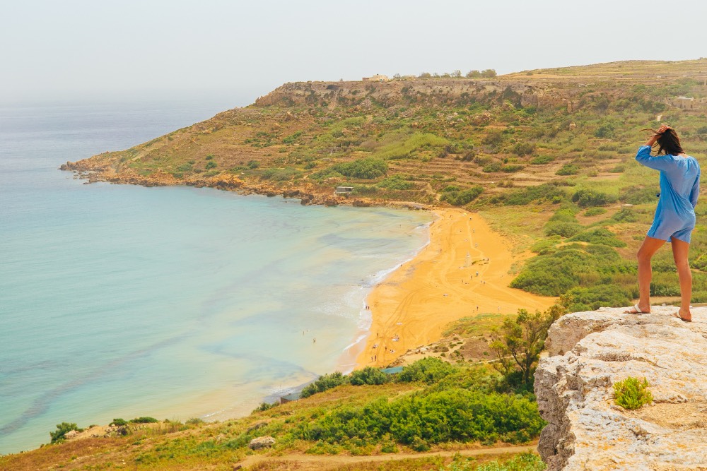 Woman overlooking Ramla Bay in Malta