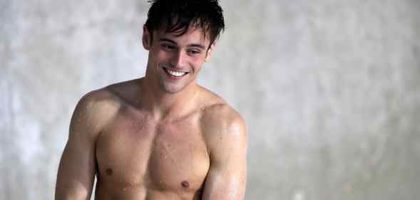 Tom Daley steps out of the pool shirtless