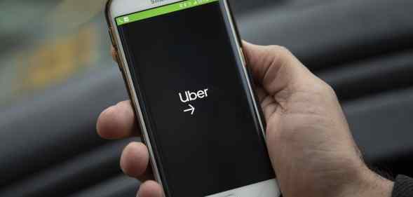 A phone displaying the Uber logo