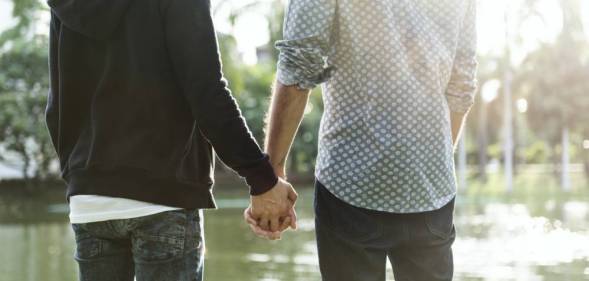 same-sex couple holding hands homophobic abuse