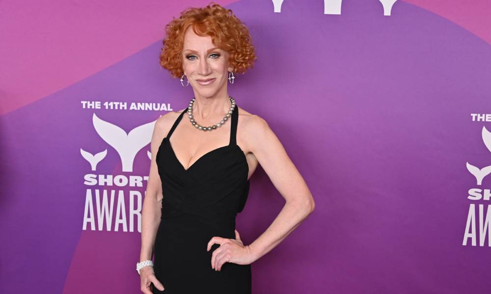 Kathy Griffin in black outfit amid purple background at the 11th Annual Shorty Awards in 2019