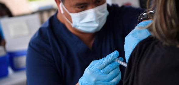 A nurse administers a dose of Covid-19 vaccine