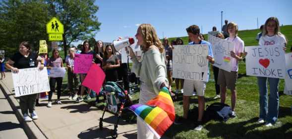 Ivie Hunt, 15, front, and about 50 Valor Christian High School students walked out of classes to support a volleyball coach Inoke Tonga, who says he was forced to leave his job over his sexuality, in front of the high school in Highlands Ranch, Colorado on Tuesday, August 24, 2021.