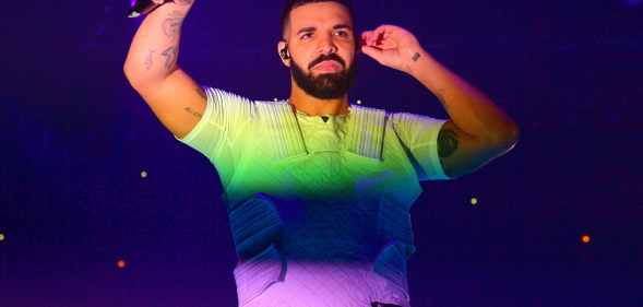 Drake with the colours of the rainbow shining on him