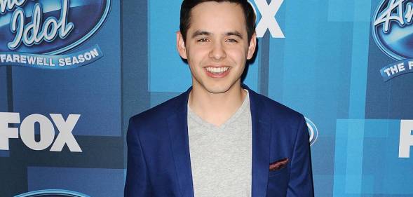 David Archuleta attends FOX's "American Idol" finale for the farewell season at Dolby Theatre in a blue suit jacket and grey shirt