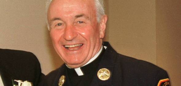 Fire Department chaplain Mychal Judge smiles for a photograph 28 July 2001, Judge was killed in the 9/11 attack later that year