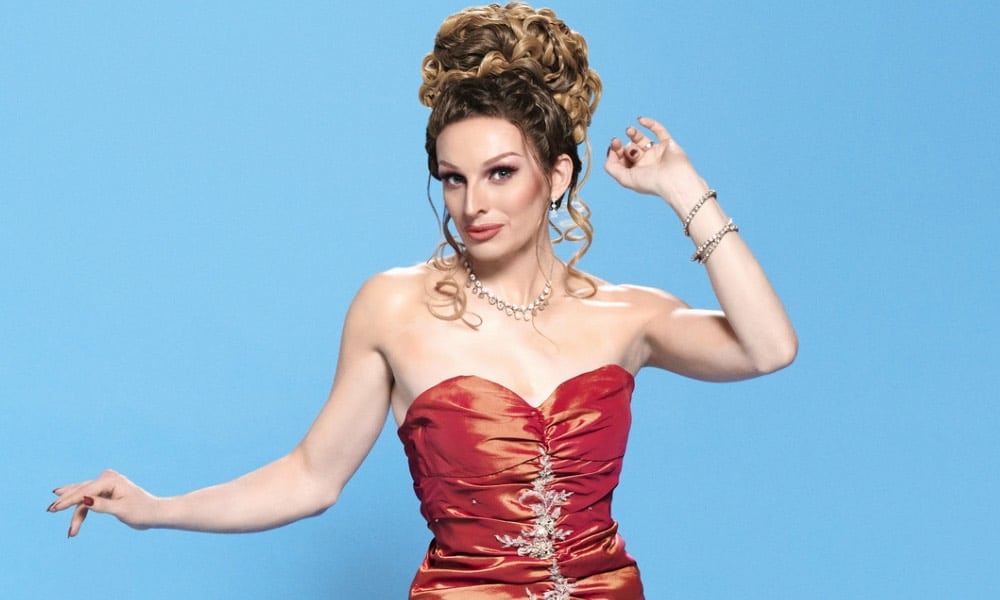 Veronica Green, a drag queen in a red dress with her hair piled on top of her head