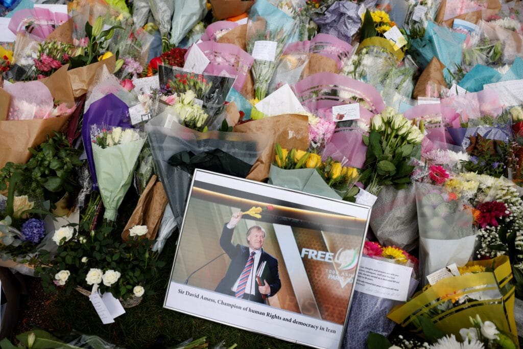 A photograph of Conservative British lawmaker David Amess is seen amid floral tributes left at the scene of the fatal stabbing