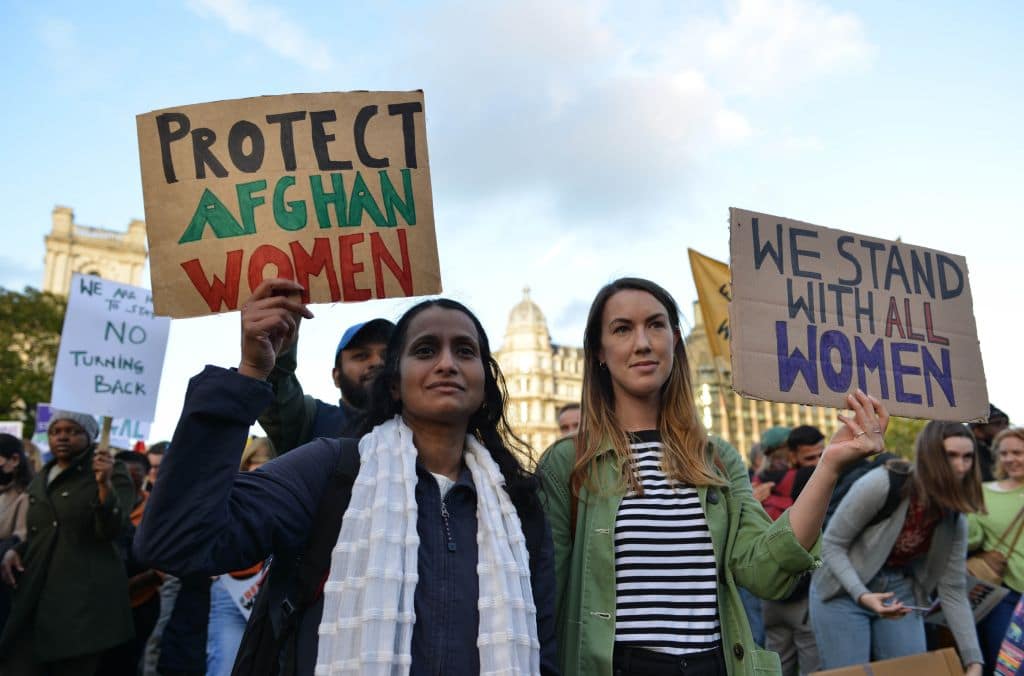 Protesters hold placards reading 'protect Afghan women'