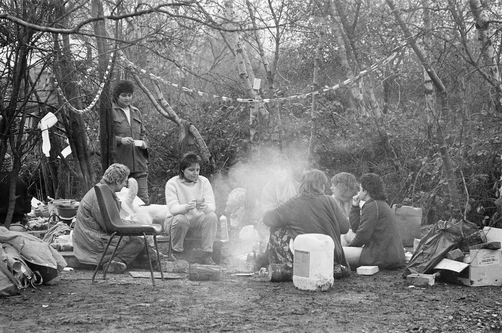 Women around a campfire at Greenham Common Peace Camp