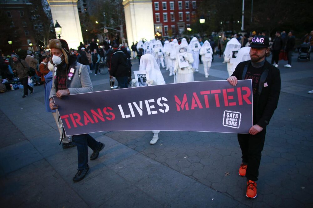 People hold a "Trans Life Matter" banner at the Transgender Day of Remembrance in Washington square park, New York