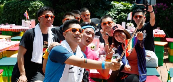 A group poses for photos at Shanghai Pride