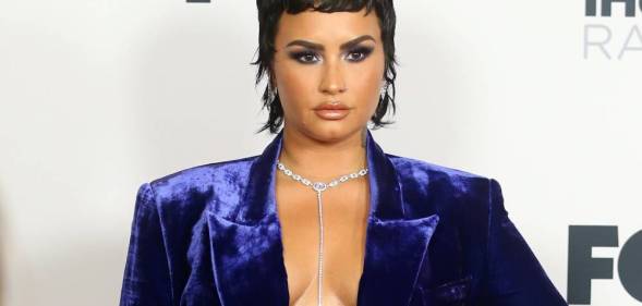 Demi Lovato appears in a blue-purple velvet outfit at the iHeartRadio Music Awards in May 2021