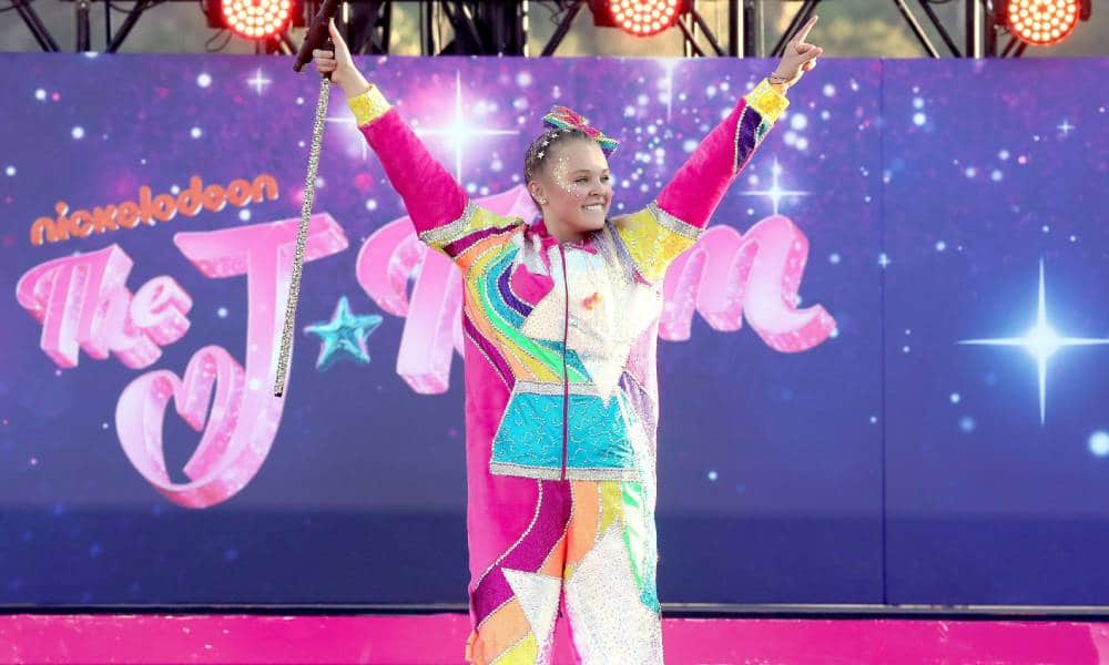 JoJo Siwa wears a sparkly velour jumpsuit to the premiere of her movie The J Team