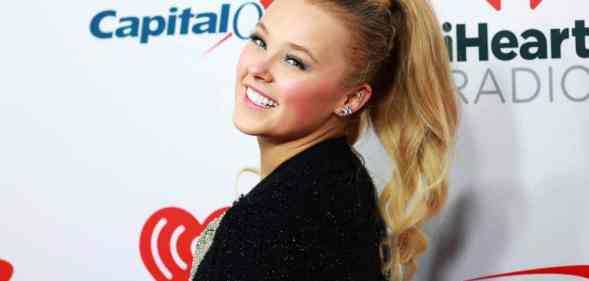 JoJo Siwa smiles as she attends iHeartRadio 102.7 KIIS FM's Jingle Ball 2021