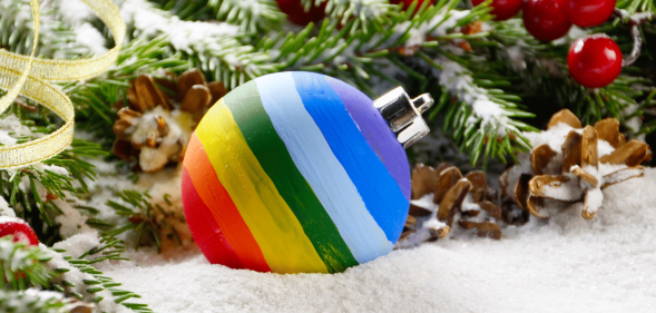 A rainbow bauble on a bed of snow