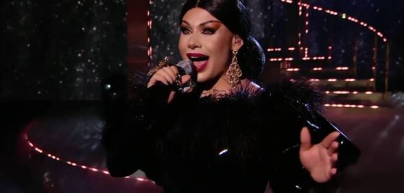 Grag Queen performs in a black dress on Queen of the Universe