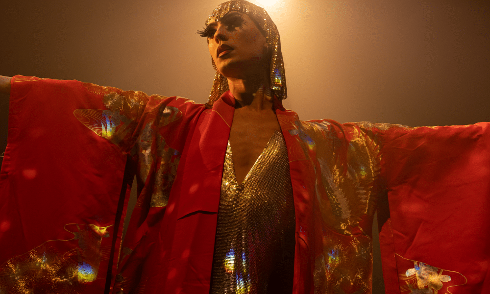 A performer in a red kimono-style garment