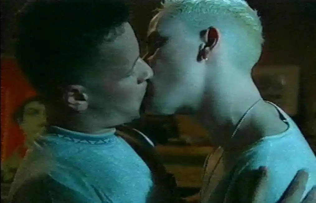 Two men kissing in a still from The Gay Men's Guide to Safer Sex.