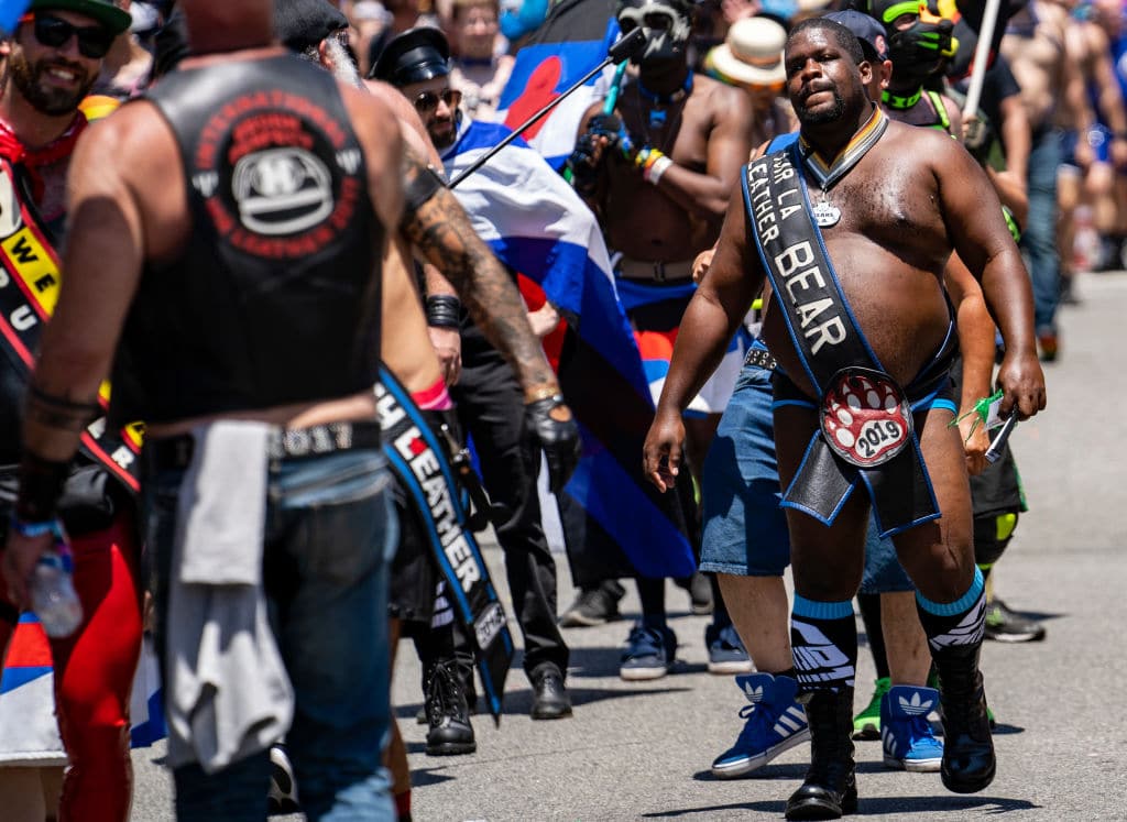 A man wears a sash that says Mr. LA Leather Bear during the LA Pride Parade in West Hollywood, California.