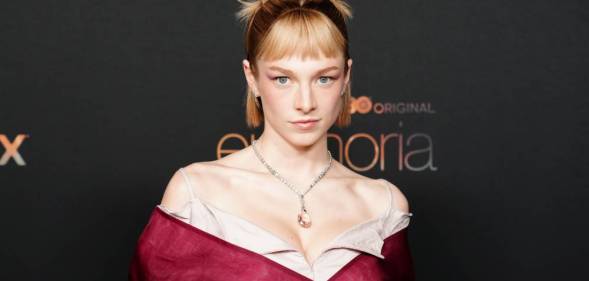 Hunter Schafer, a star of the HBO show Euphoria, looks at the camera while wearing a red dress