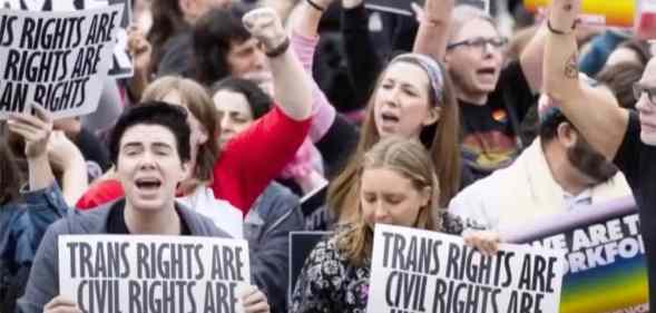 People holding up signs that read "Trans rights are civil rights are human rights"