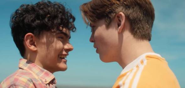 A still of Heartstopper characters Charlie and Nick on the beach from the Netflix show