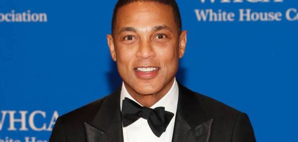 Journalist Don Lemon smiles at the camera while wearing a white shirt black bow tie and black suit jacket