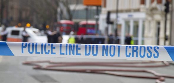 Police tape across a road