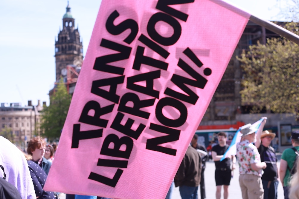 A flag reads "trans liberation now"