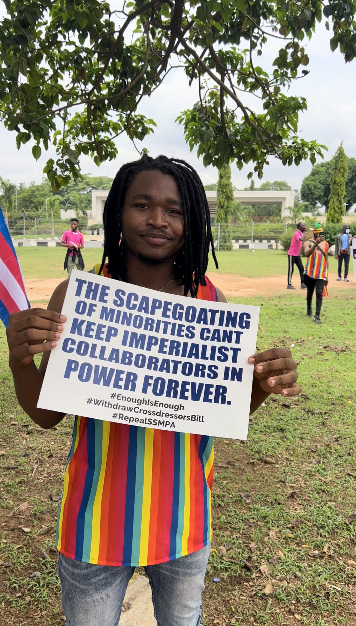Ani Kayode holding a placard at a protest in Nigeria. 