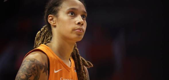 US basketball star Brittney Griner wears an orange jersey while looking up