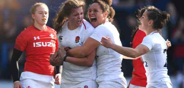 English women's rugby players cheer and shout on the field