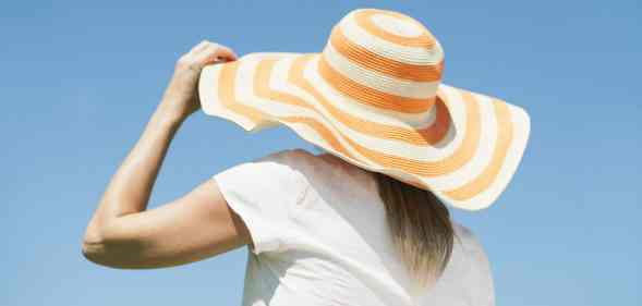 Woman wearing a sun hat looking away from the camera