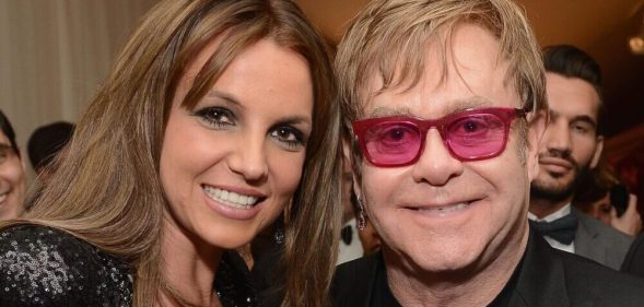 Britney Spears smiling next to Elton John