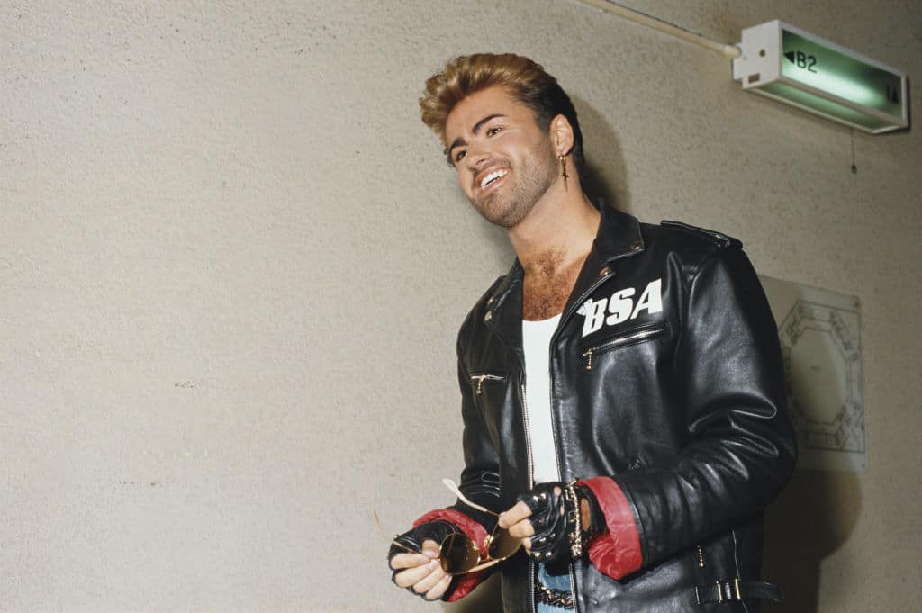 George Michael (1963-2016) pictured wearing a leather jacket with BSA logo backstage during the Japanese/Australasian leg of his Faith World Tour. 